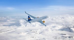 Icelandair 737 MAX flying over snowy terrain