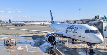 A JetBlue A220 at the gate in Boston