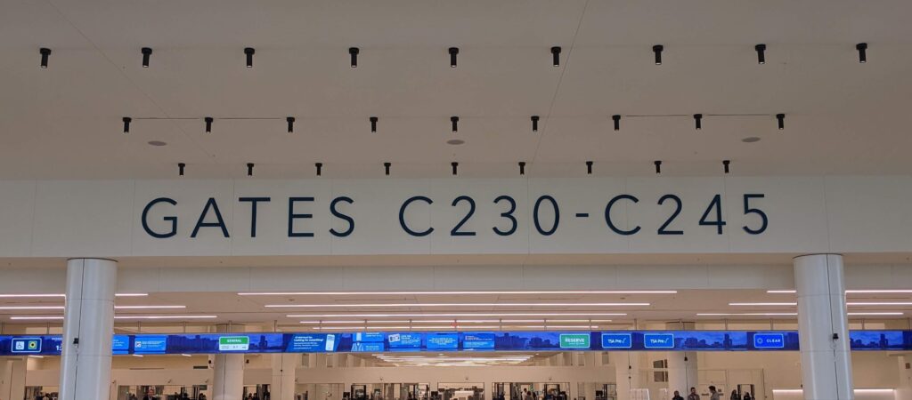 entrance to security area and an airport, with large letters indicating the gates