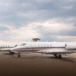 business jets parked at an airport