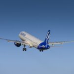 An Aegean A321neo flying away into blue skies
