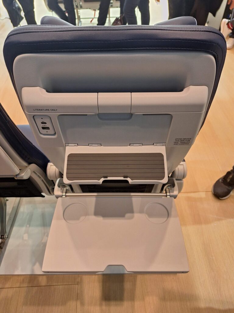 Convenient access to power, a device holder, and dual cup positions are all part of the seatback layout on Southwest's new seats, as developed with Recaro and Tangerine