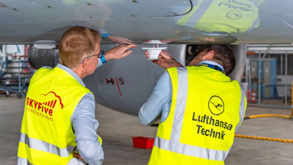 Executives from SkyFive and Lufthansa Technik inspect an ATG antenna installation
