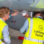 Executives from SkyFive and Lufthansa Technik inspect an ATG antenna installation
