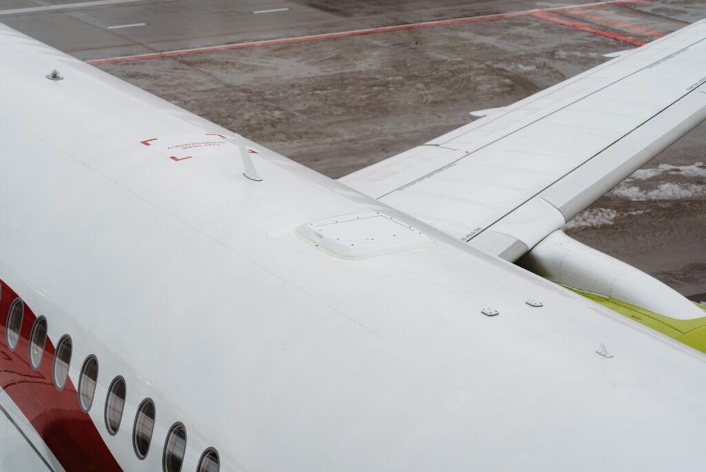 The small Starlink antenna sits atop an airBaltic A220-300