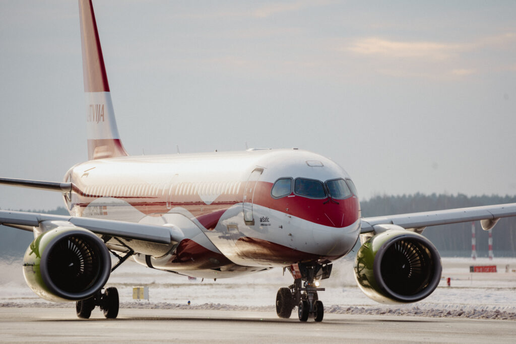 airBaltic's Latvia special livery aircraft on the runway, with the Starlink antenna installed on board