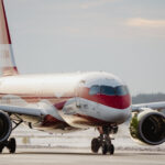 airBaltic's Latvia special livery aircraft on the runway, with the Starlink antenna installed on board