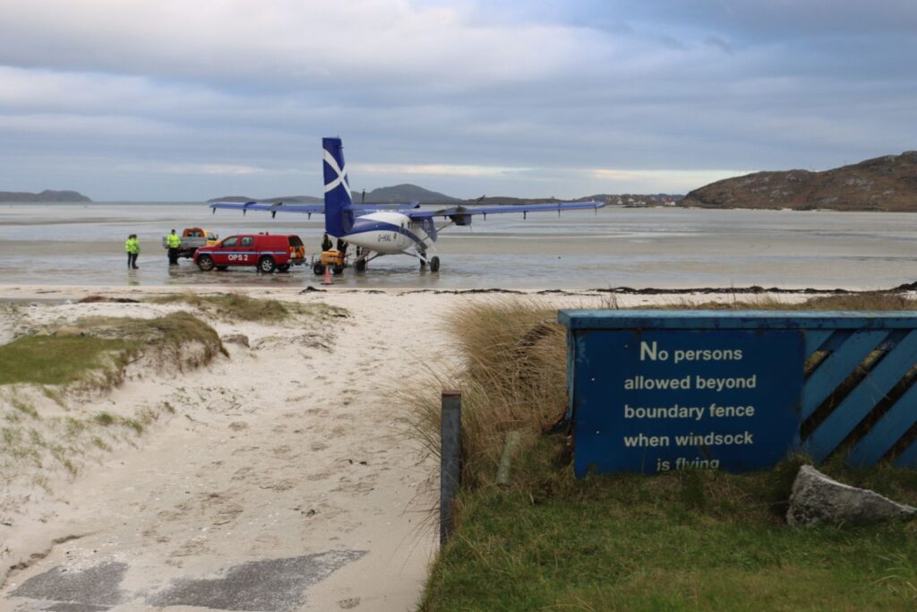Loganair's Twin Otter parked on the beach in Barra, prepping for the return to Glasgow