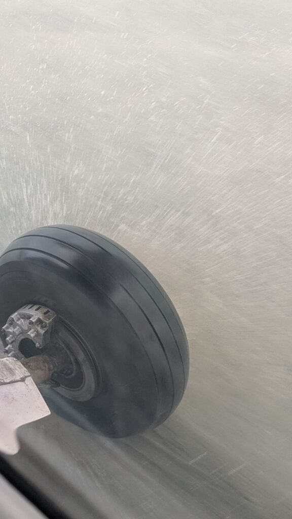 The wheels kicking up salt water on the beach as we landed on Barra's beach runway
