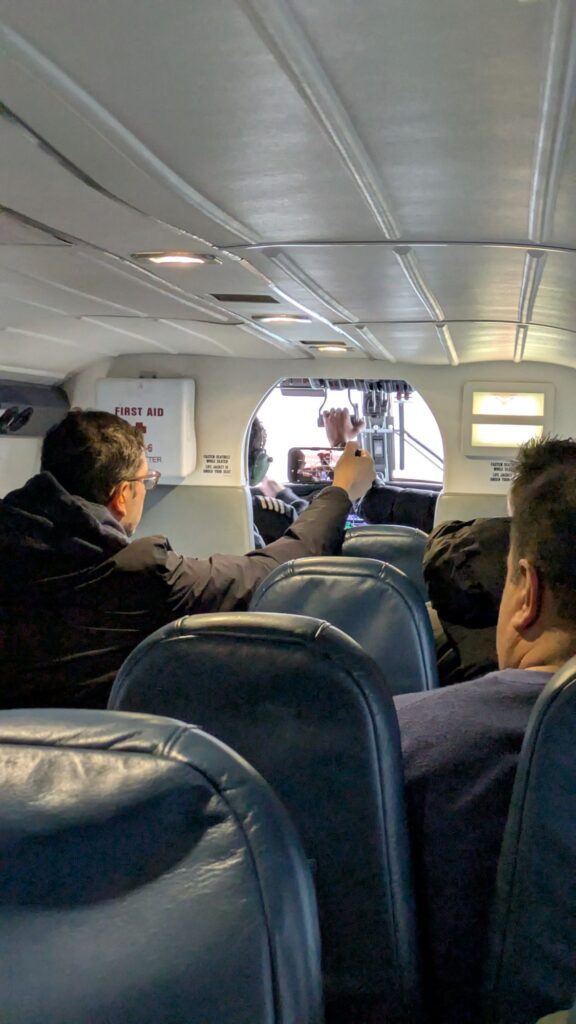 Sit up front and lean in to the aisle for a view out the front of the Twin Otter