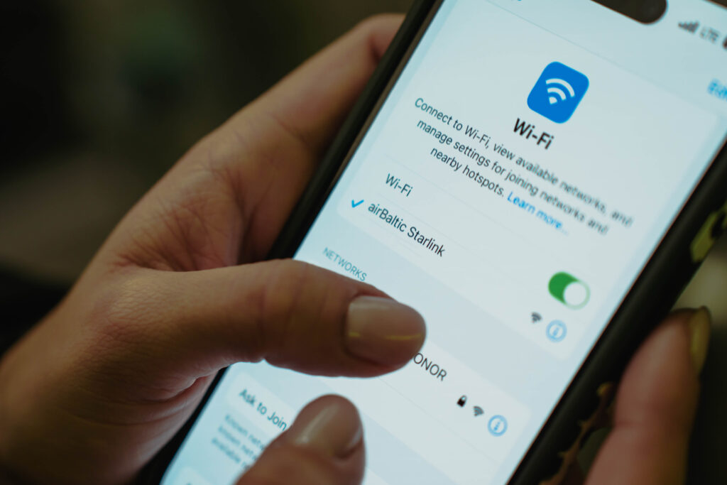 Selecting the airBaltic Starlink wifi network on an iPhone
