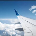 wifi logo clouds over an airplane wing