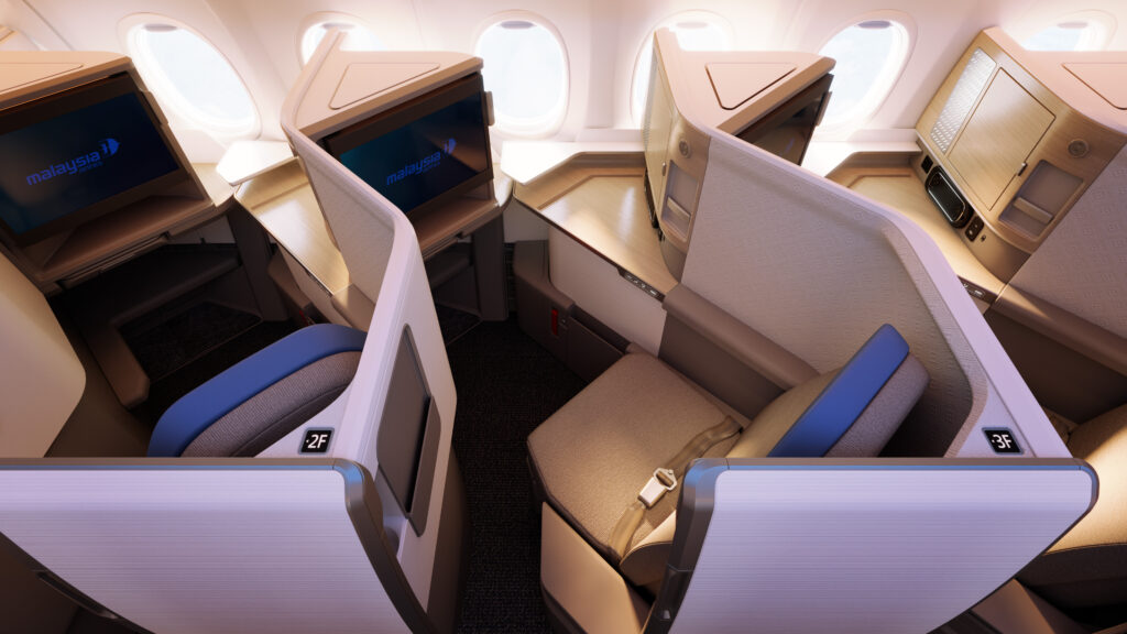 Pair of business class seats angled towards the window.