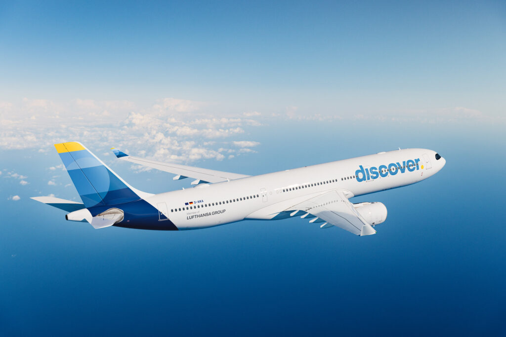 A Discover A330 flying across blue skies.