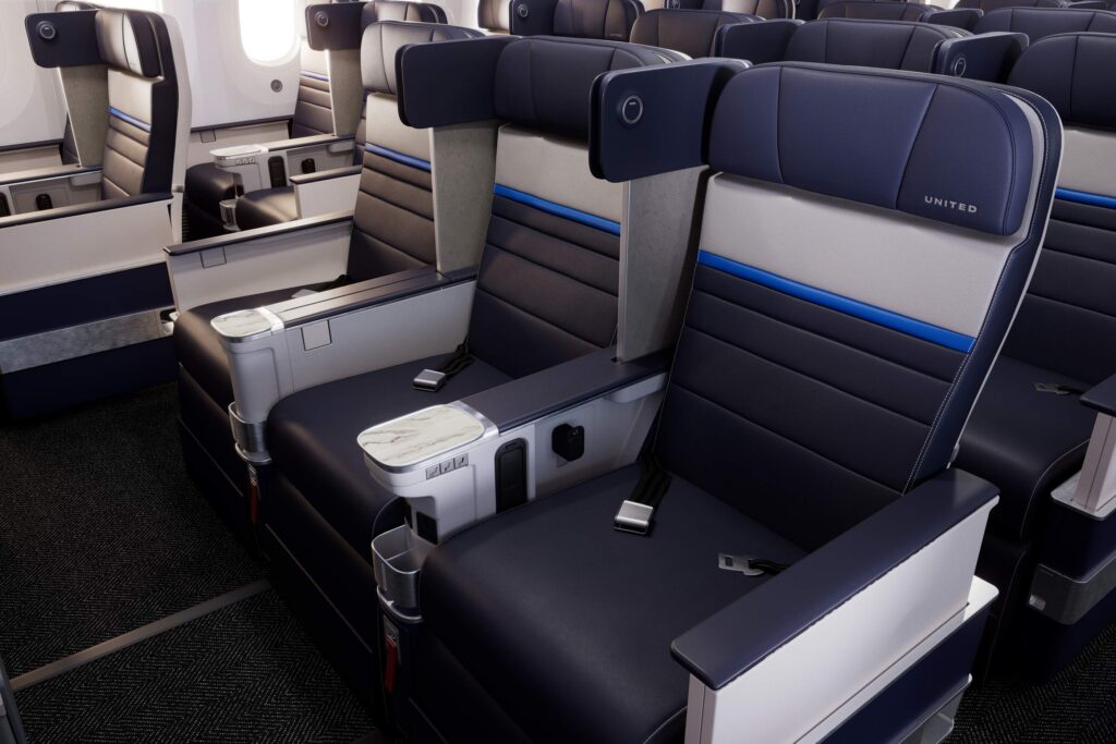 Privacy dividers are part of the new Premium Plus seats, as is wireless charging for phones (Image via United)