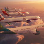 five planes rendered next to each other in flight at sunset