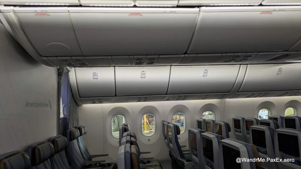 Overhead stowage is limited for the last few rows in economy, plus a hard bulkhead limiting recline in the center, but just a curtain for the outboard pairs
