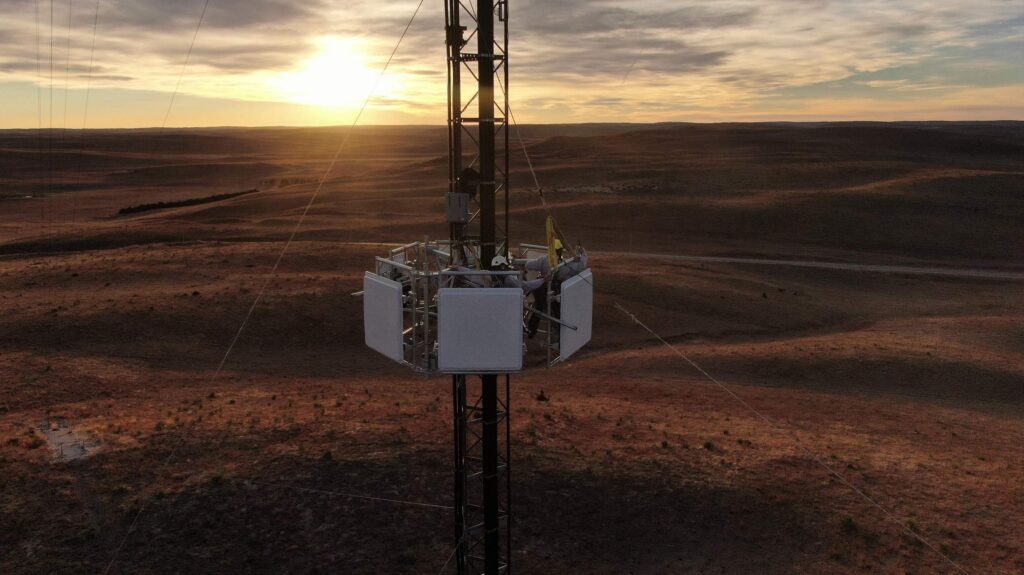 cell tower in a field at sunset