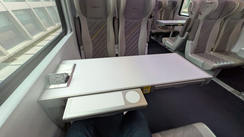 Pair of empty train seats with a table .