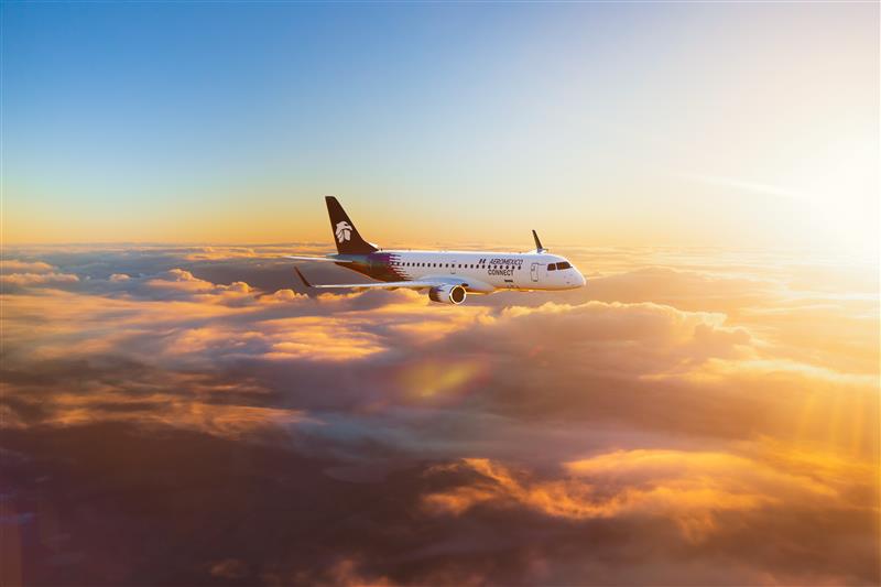 rendering of an Aeromexico E190 flying above the clouds with orange sunlight lighting things up