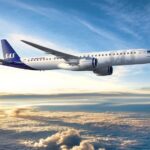 Rendering of the E195-E2 in the SAS livery, flying above clouds.