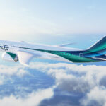 White 787 with greens and dark blues on the tail representing the northern lights