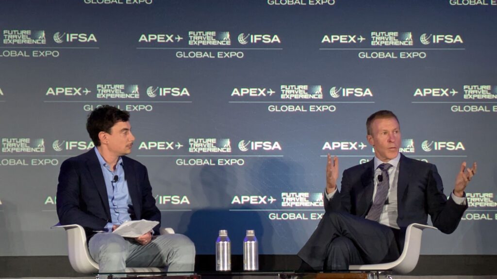 two guys on stage at a conference