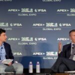 two guys on stage at a conference