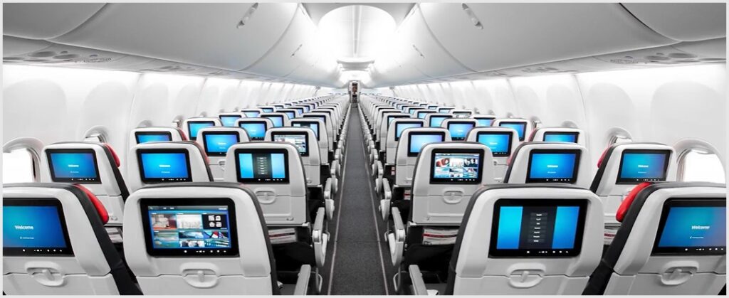 lots of screens on economy class seats in a 3-3 layout