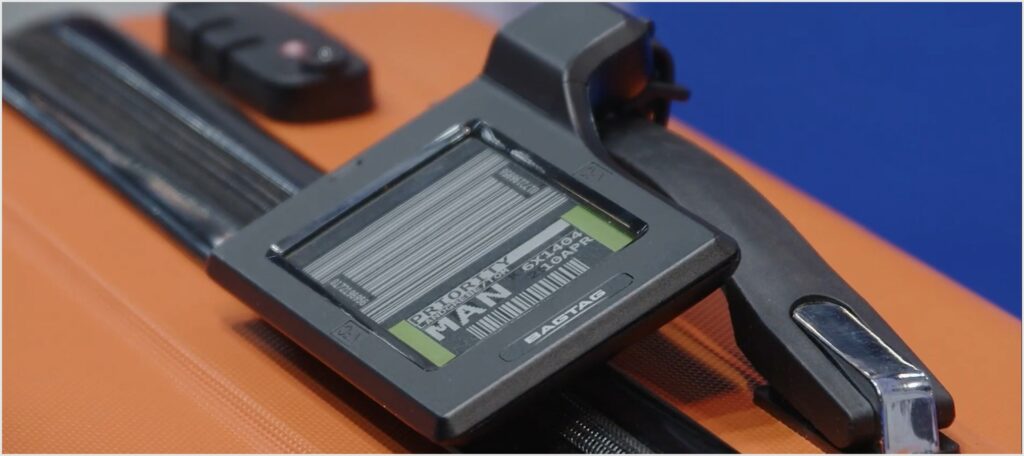 digital bag tag on an orange suitcase