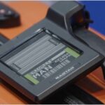 digital bag tag on an orange suitcase