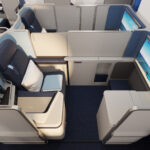 The front row of business class on Edelweiss's new A350 cabin features privacy doors and a bit of extra space, plus a larger IFE screen.