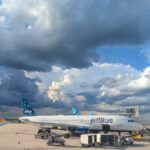 Storm clouds over JetBlue planes at an airport