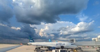 Storm clouds over JetBlue planes at an airport