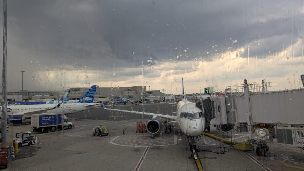 Rain and storm clouds over the JetBlue planes parked at Boston