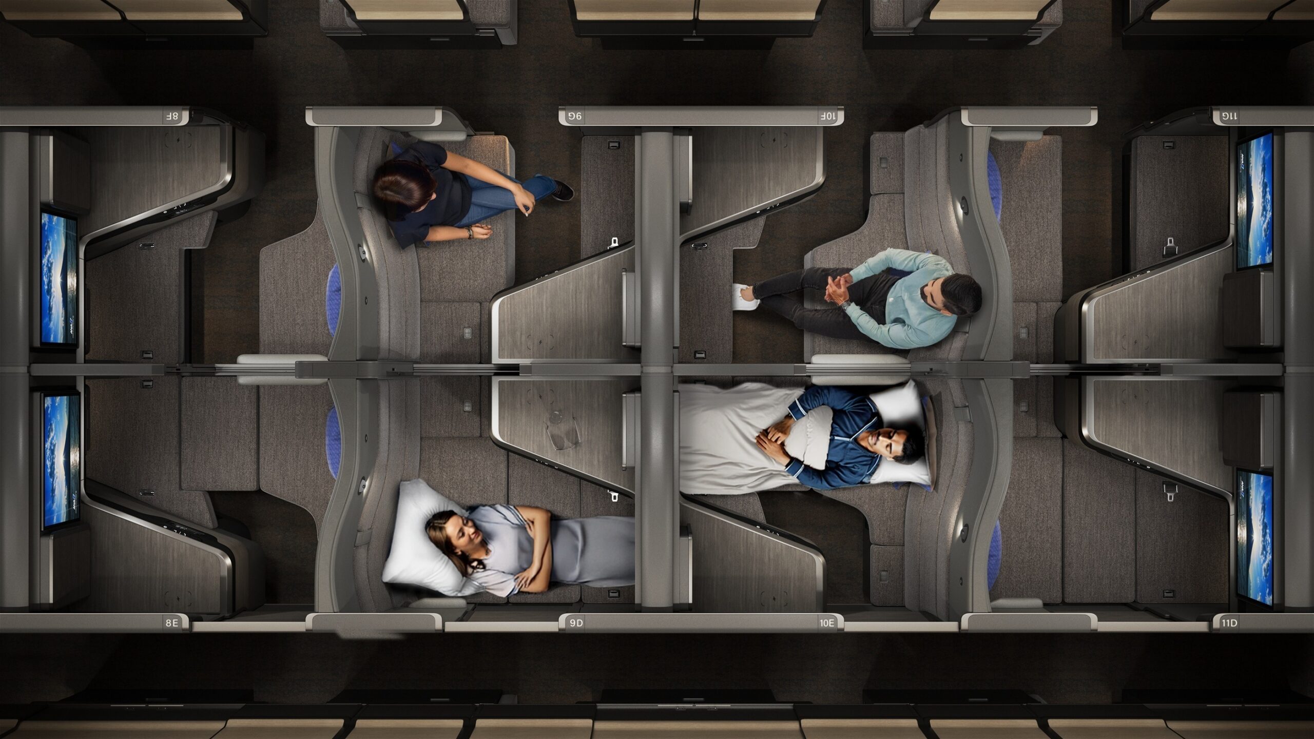 250529_bus_stills_delivery_4k_cabin__0011-with-people_seats-and-beds birdseye view of a business class cabin with seats/suites alternating direction.