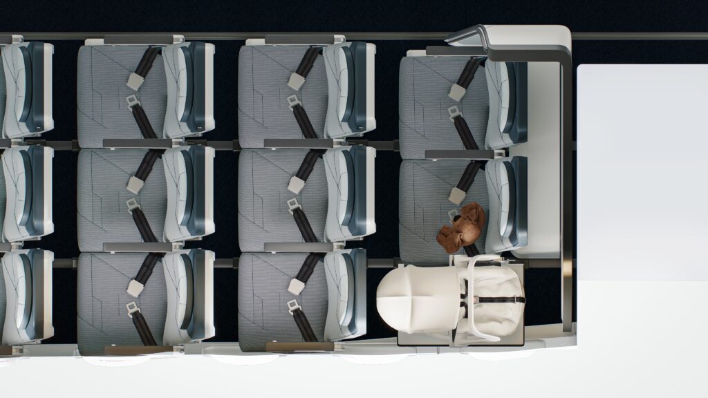 Birdseye view of a few rows in economy class on a plane, where the back row is configured with the Collins Aerospace SkyNook, an area too small for a seat replaced by a baby carrier.