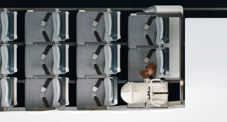 Birdseye view of a few rows in economy class on a plane, where the back row is configured with the Collins Aerospace SkyNook, an area too small for a seat replaced by a baby carrier.
