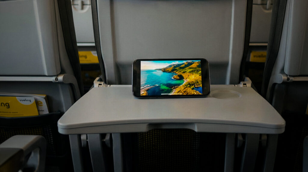 Watching streaming IFE on a small screen, set on a tray table on a Vueling plane