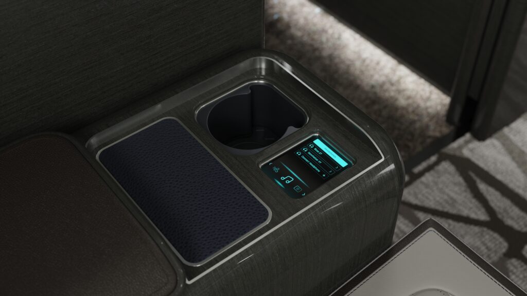 Close up of an arm rest console on an Embraer business jet including controls for entertainment and cabin comfort.