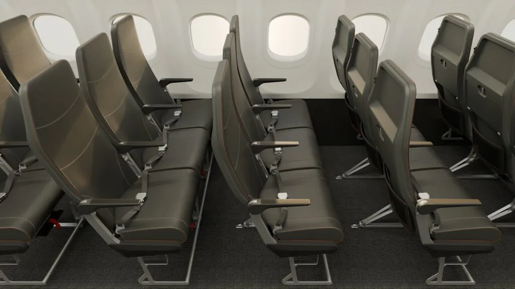 Rows of very slimline, dark grey, economy class seats in an easyJet cabin mockup.