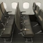 Rows of very slimline, dark grey, economy class seats in an easyJet cabin mockup.