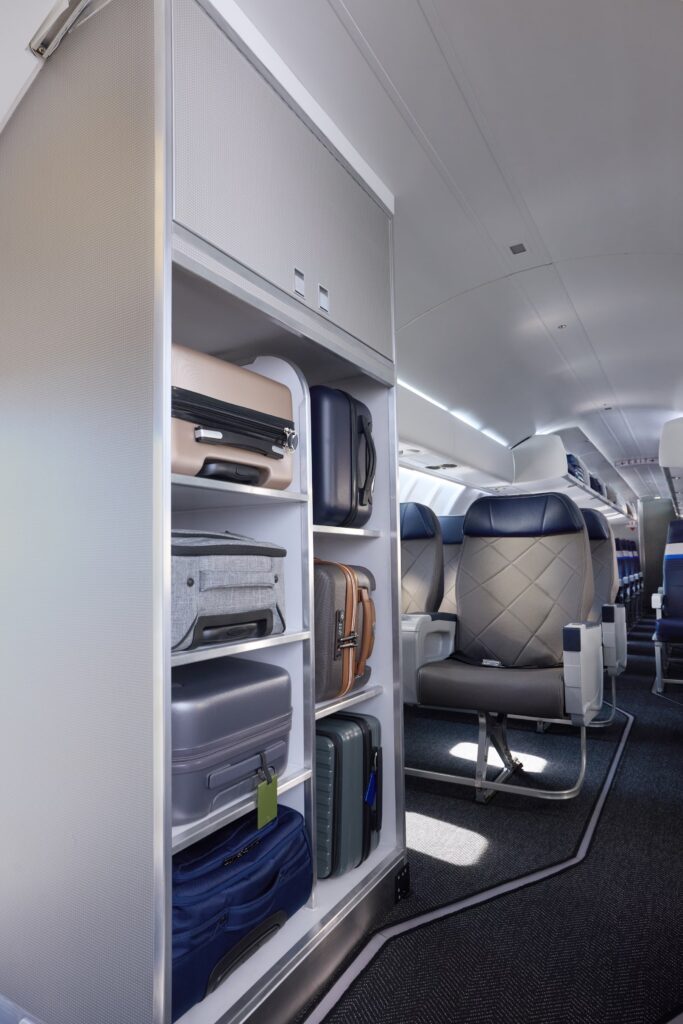 Vertical view of the first class closet on the United CRJ450, with seven slots for bags matching the seven seats in the cabin.
