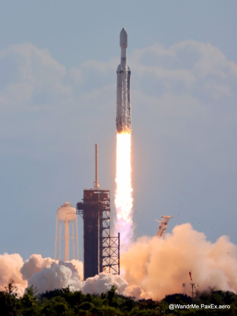 Launch of a Falcon Heavy rocket, with three boosters all firing, as it clears the tower in Florida.
