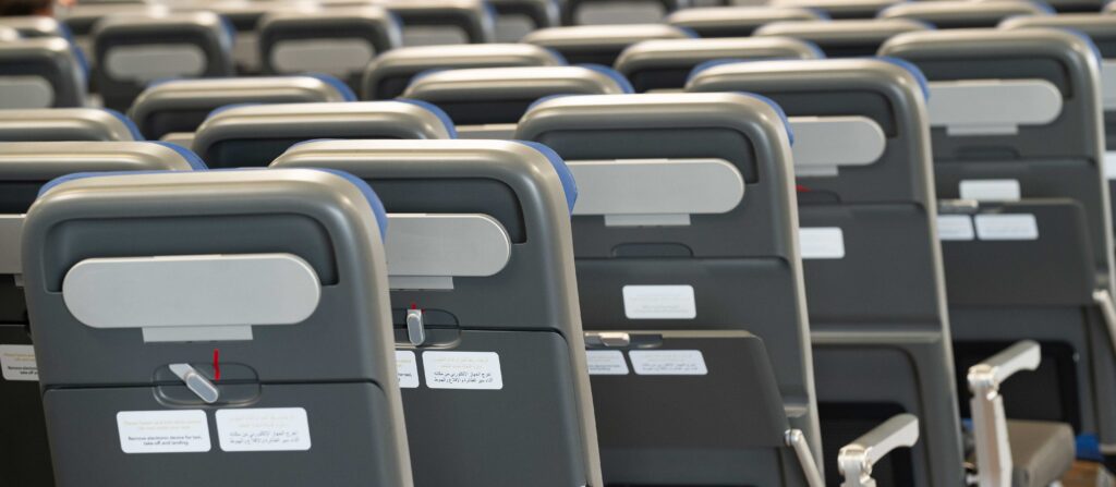 rows of economy class seats in a factory setting.