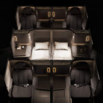 overhead of three rows of Unum Two business class seats in a very dark color scheme