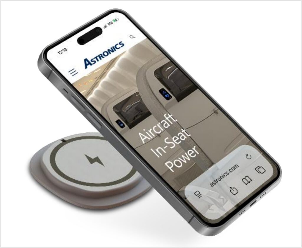 mobile phone hovering over the new Astronics emPower Qi2 wireless charging interface.