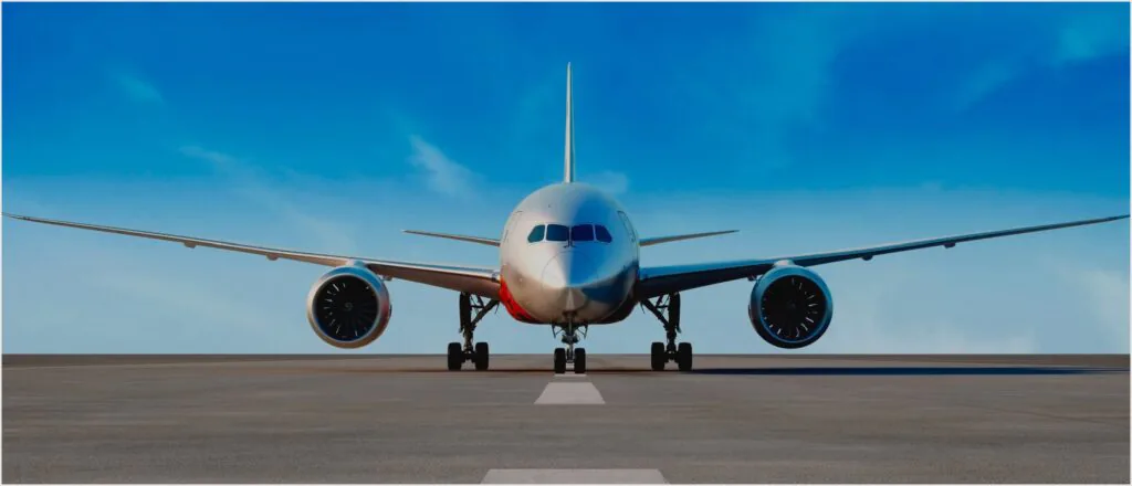 nose-on view of a 787 on the ramp with blue skies behind.