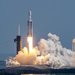 Launch of a Falcon Heavy rocket, with three boosters all firing, as it clears the tower in Florida.