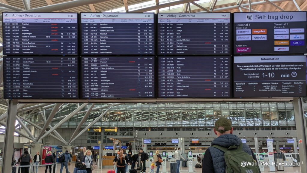 A man studying the departures board at Hamburg Airport.